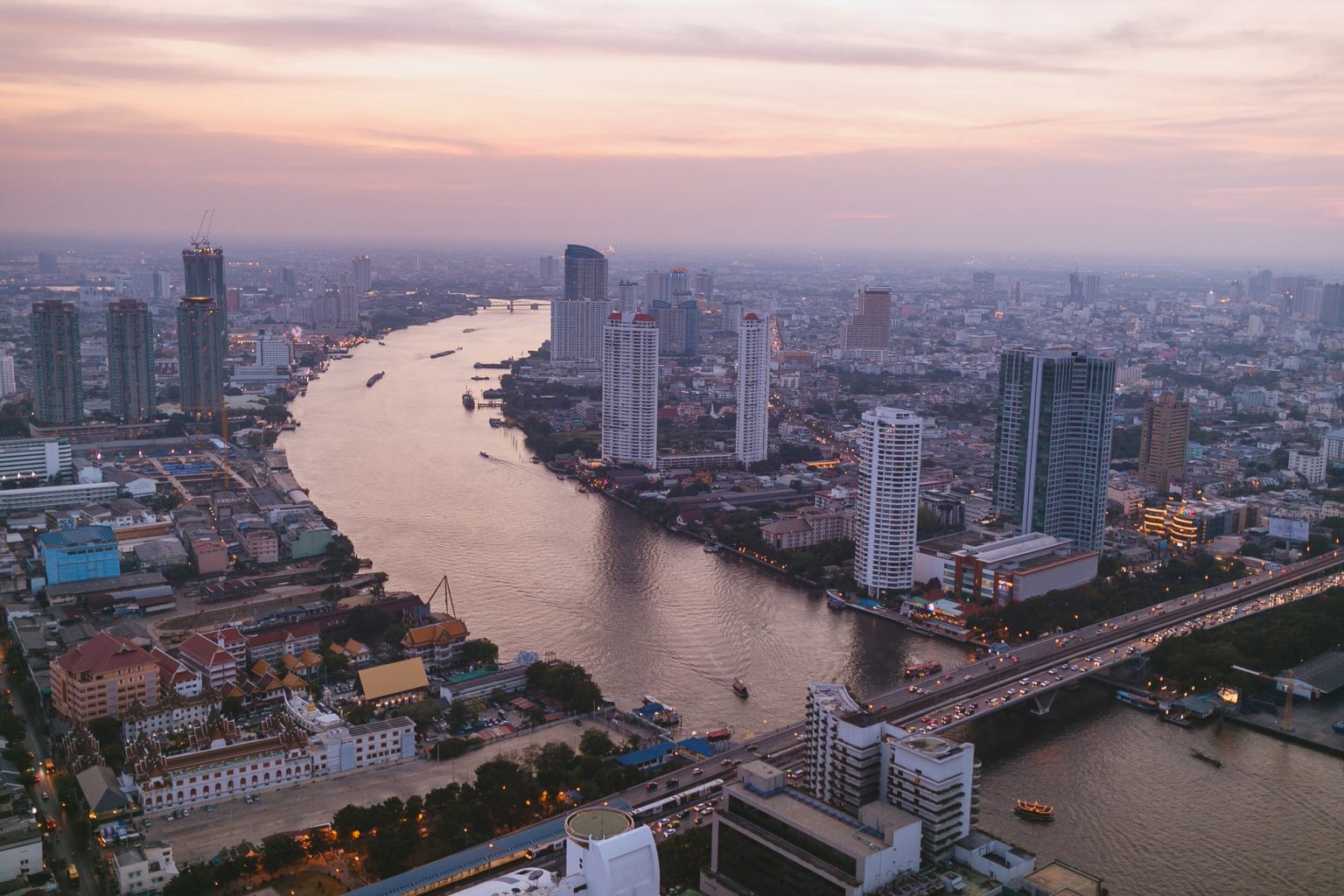 aerial view of sunset over skyscrapers and river in bangkok, thailand aerial view of sunset over skyscrapers and river in bangkok, thailand